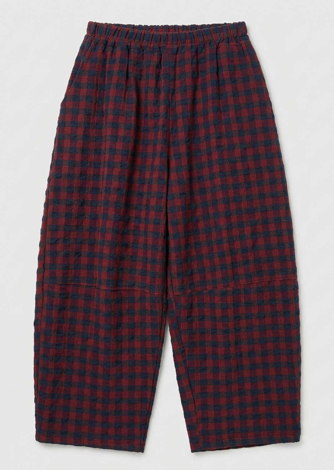 Red and navy blue checkered cropped pants with an elastic waistband, shown flat against a light gray background.