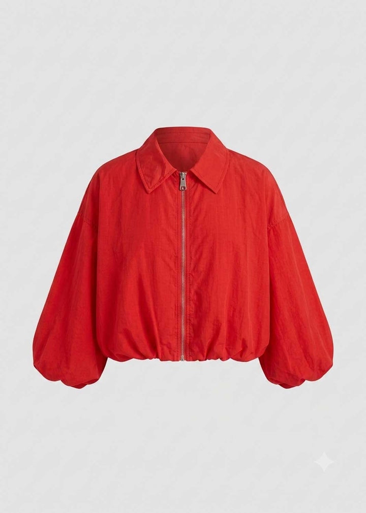 A bright red cropped jacket with a collar, front zipper, and voluminous balloon sleeves, shown against a light gray background.