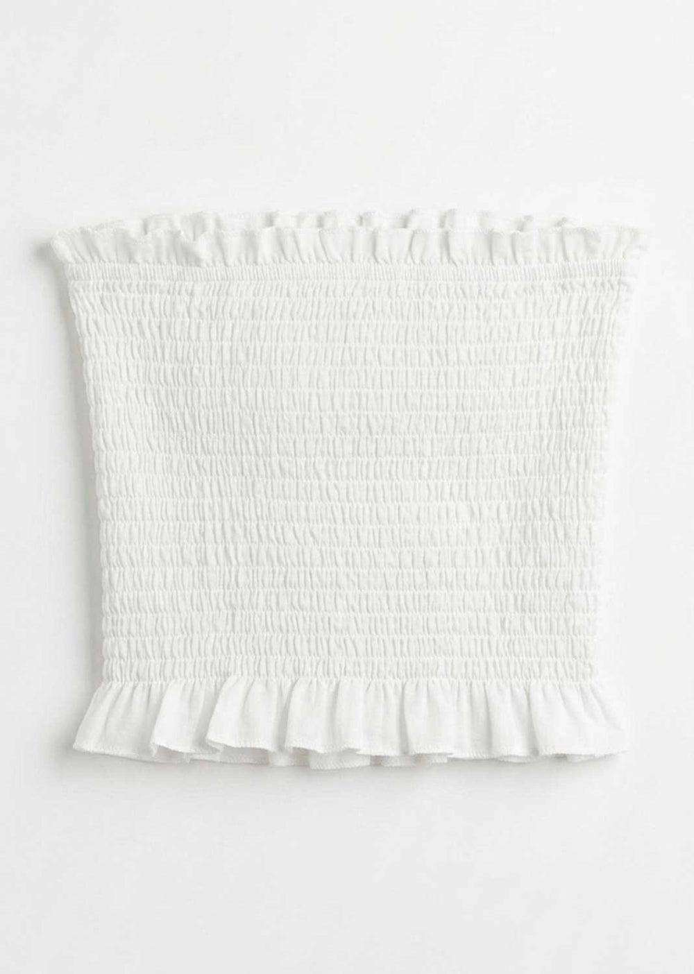 White smocked tube top with ruffled trim at the neckline and hem, shown flat against a white background.